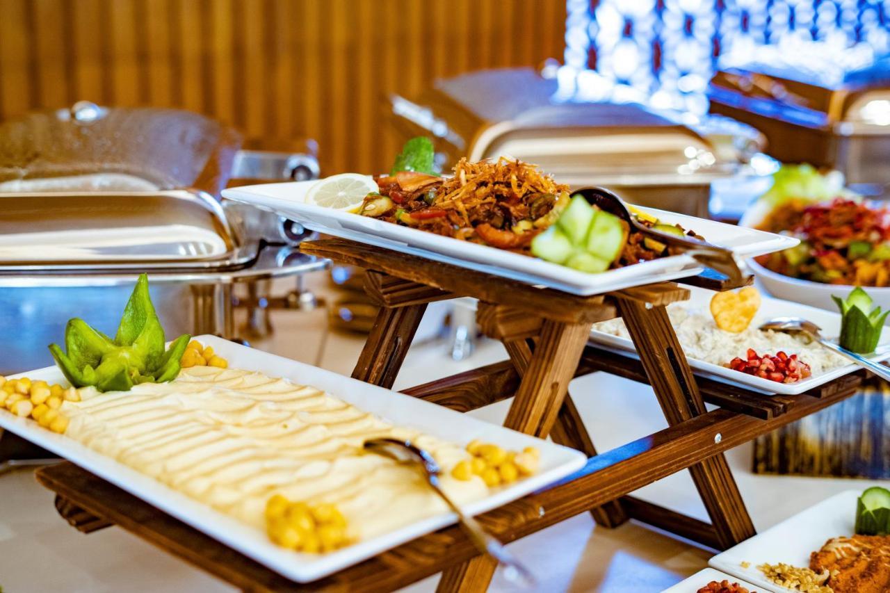 Luxe Grand Hotel Apartments Sharjah Esterno foto A buffet at a hotel