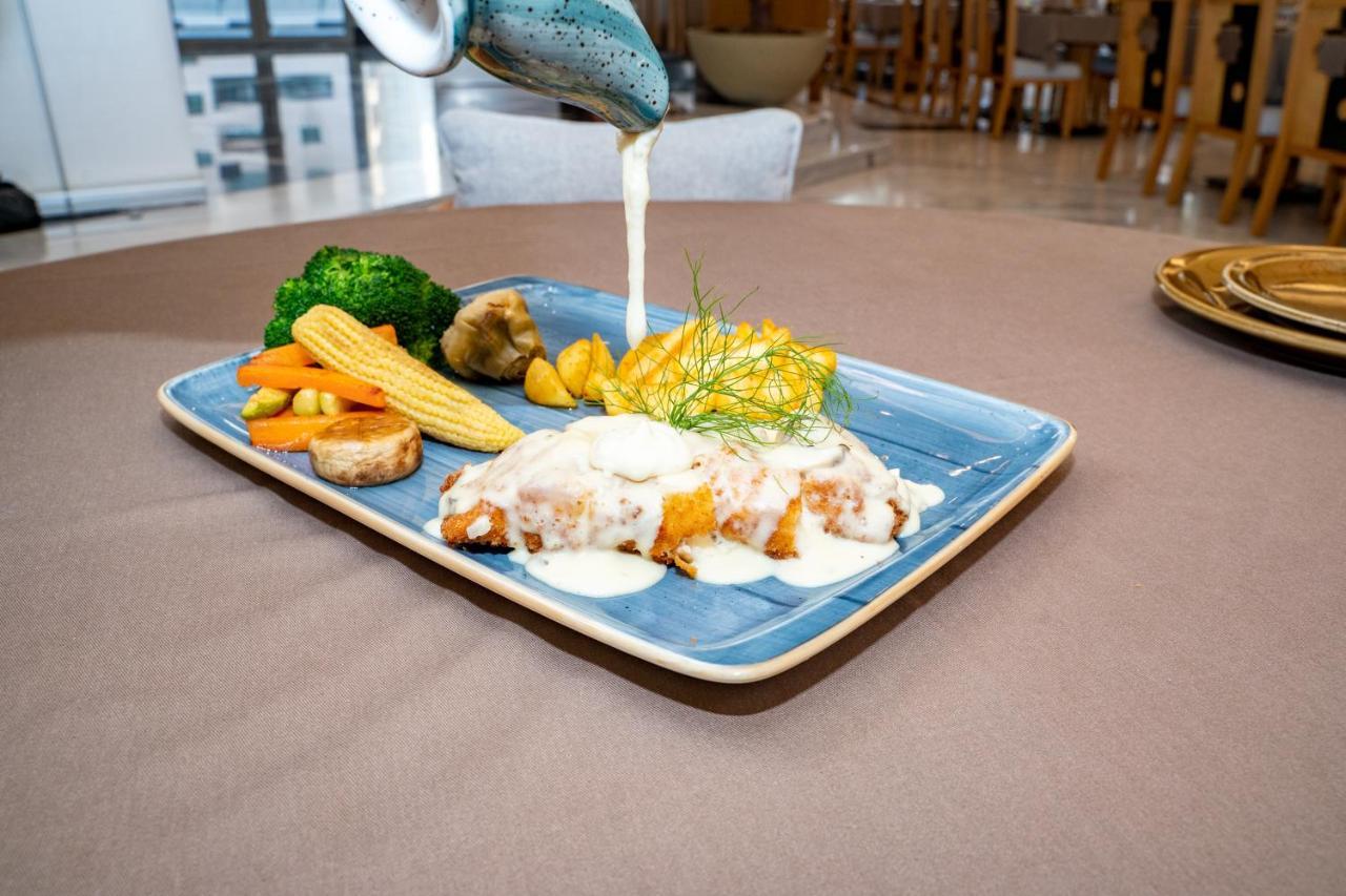 Luxe Grand Hotel Apartments Sharjah Esterno foto A plate of food being served