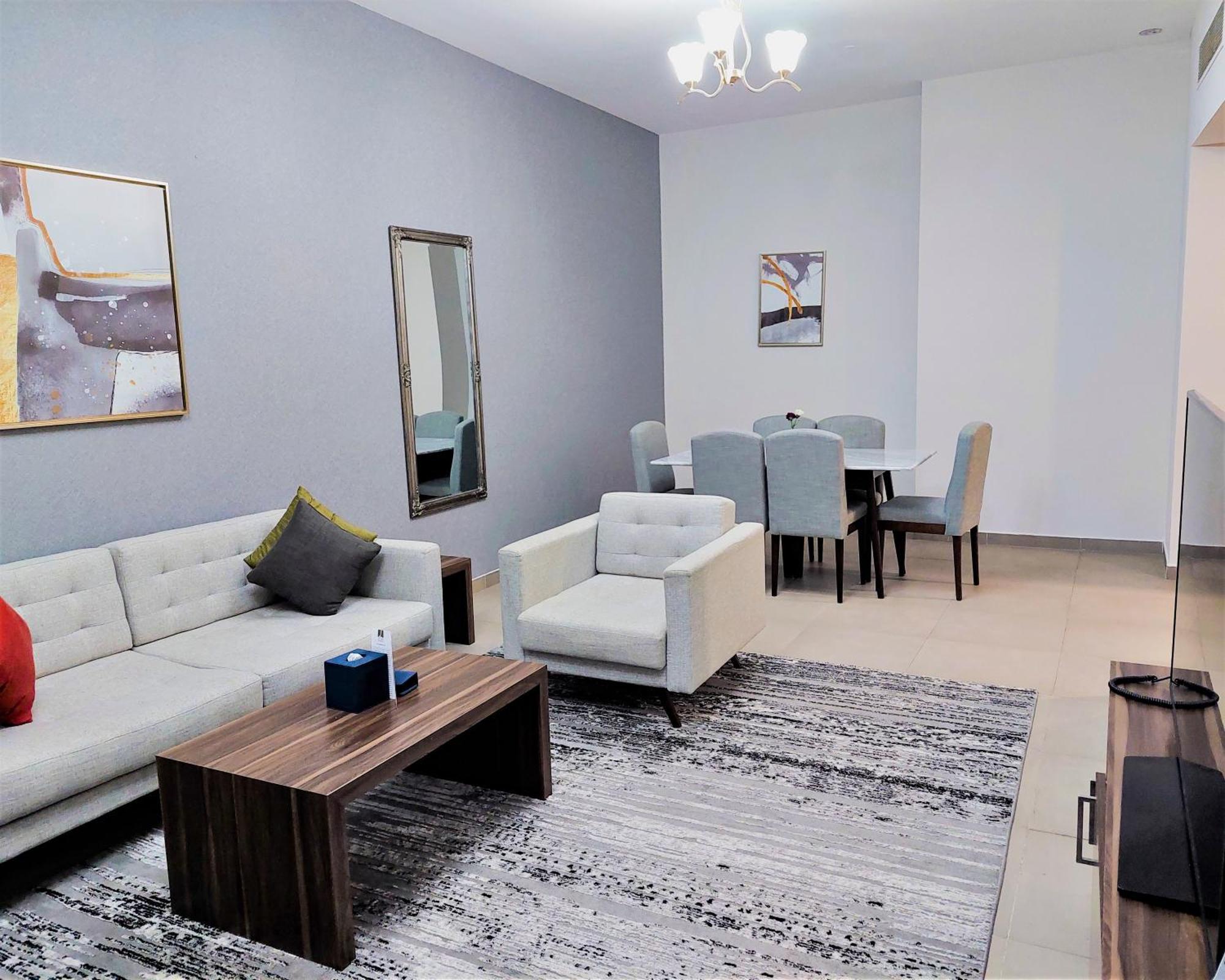 Luxe Grand Hotel Apartments Sharjah Esterno foto A living room in a typical apartment
